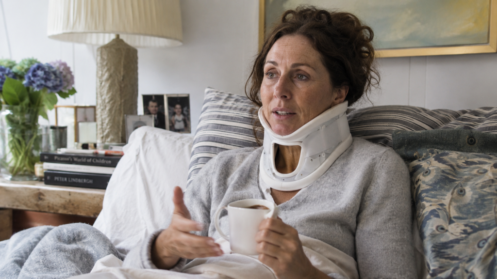 Celebrity inspired actress recovering at home wearing a neck brace after a serious car accident